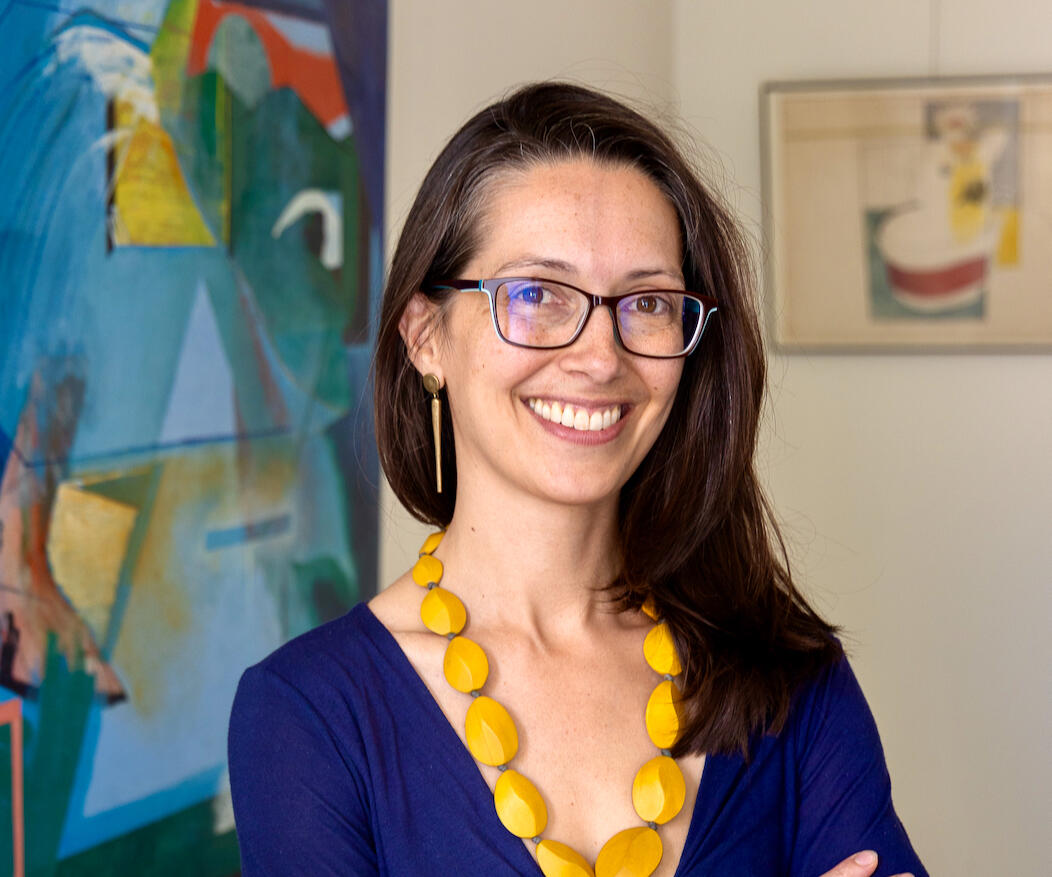 Laura Mary Cincotta - The Designer's Translator. Headshot with artworks by painter Martha D. Gerardo in the background. Credit: Jennifer Skinner
